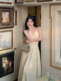 2025 neck V-neck suspender dress women's spring and summer temperament waist pleated A-shaped skirt vacation style medium and long skirt