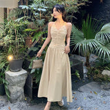 2025 neck V-neck suspender dress women's spring and summer temperament waist pleated A-shaped skirt vacation style medium and long skirt