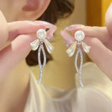 Bow pearl stud earrings new trendy long fringed earrings women's light luxury temperament versatile high-end silver needle earrings