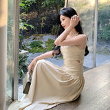 2025 neck V-neck suspender dress women's spring and summer temperament waist pleated A-shaped skirt vacation style medium and long skirt