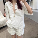 2025 Korean atmosphere wearing white hollow shirt shorts two-piece set  super fire age reduction spring women's clothing