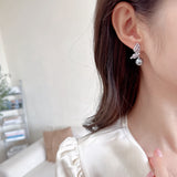 2025 Temperament niche high-end earrings wholesale new trendy fashion small simple zircon inlaid pearl butterfly earrings